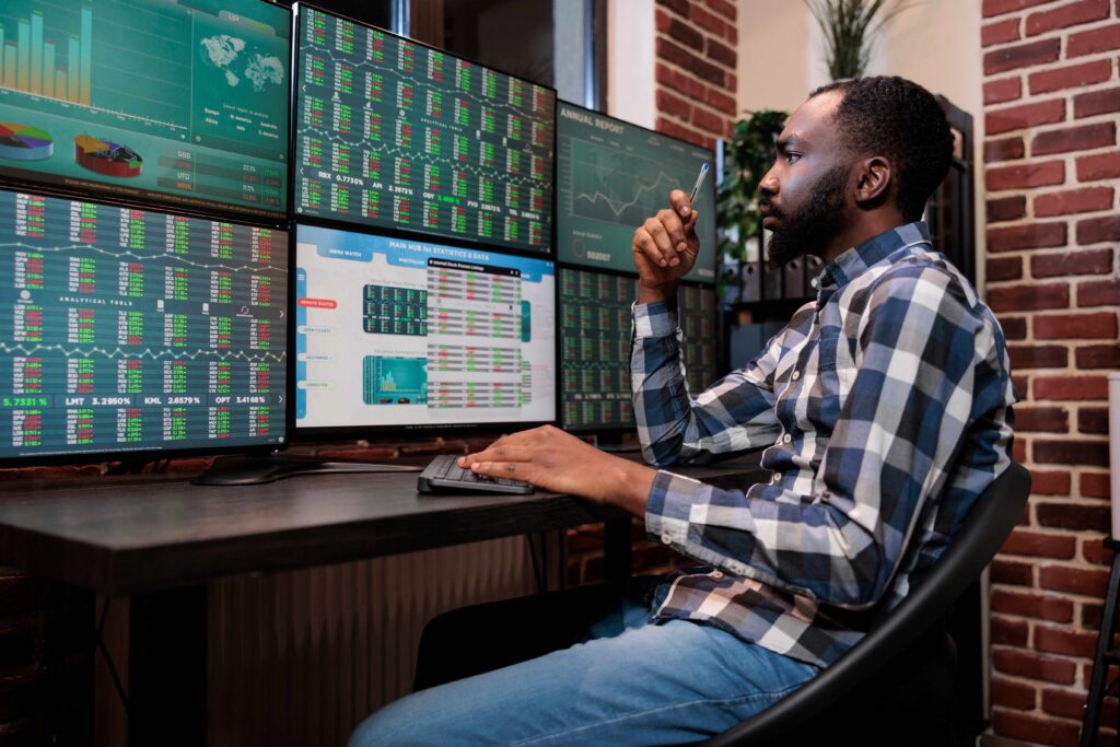 The man is analyzing stock data and making decisions based on how stocks work.