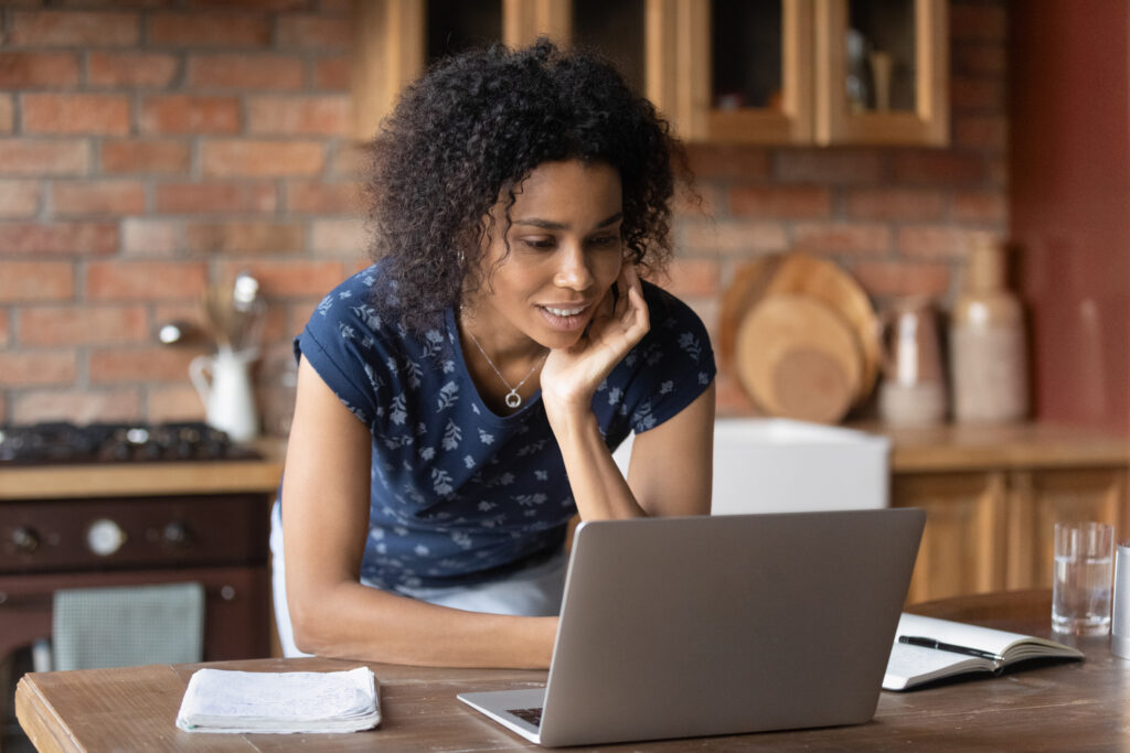 A woman looking at her laptop and trying to understand why loans get rejected